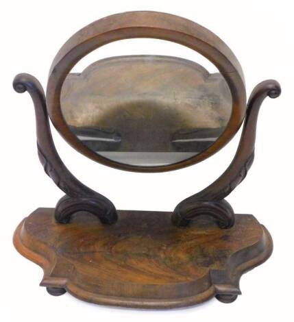 A Victorian mahogany swing frame dressing table mirror, on shaped supports with serpentine moulded base with bun feet, 70cm W.