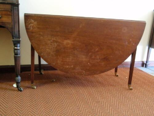 A Regency mahogany drop leaf table with oval top