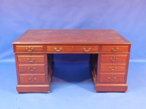 An early 20thC panelled mahogany partners desk with leather inset top