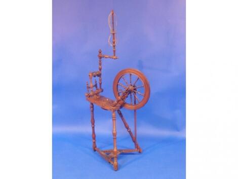 A 19thC turned walnut spinning wheel