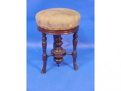 A Victorian mahogany circular rise and fall piano stool