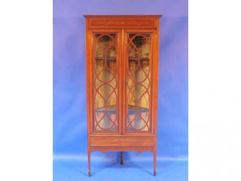 An Edwardian mahogany and satinwood cross banded corner cabinet with two