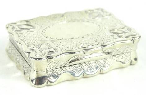 A Victorian silver vinaigrette, of rectangular form, engraved with leaves, geometric devices and with a vacant cartouche to the hinged lid, the silver gilt interior with a pierced scroll grill, Birmingham 1868 by maker George Unite, 4cm W.