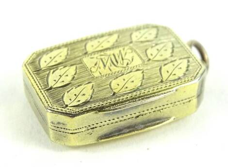 A Victorian silver gilt vinaigrette, the hinged lid decorated with leaves around a monogram within a rectangular cartouche, the hinged lid enclosing a lozenge shaped pierced grill, Birmingham assay, makers stamp IW, 2.5cm.