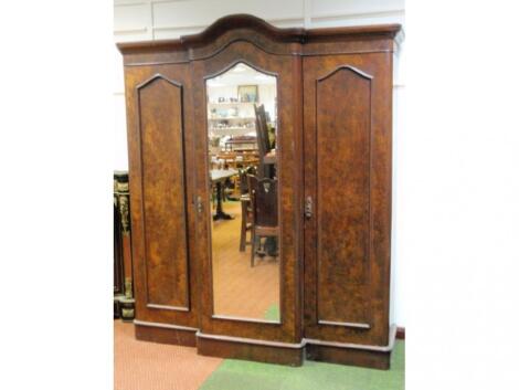 A Victorian burr walnut triple wardrobe