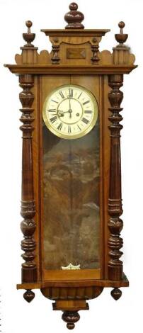 A Gustav Becker Vienna wall clock, in a walnut case, the cream coloured dial with Roman numerals, the case with turned pilasters, 127cm H.