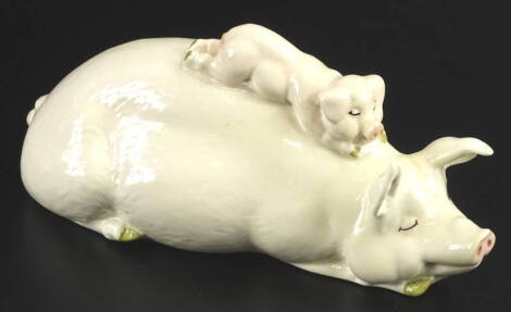 A Beswick ceramic pig group, modelled in the form of a sow with a piglet on her back, 16cm W.