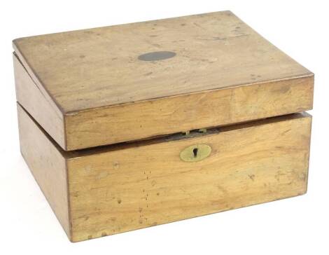 A Victorian walnut writing box, the rectangular top with a vacant oval brass cartouche enclosing a writing slope with inset velvet, 30cm W.