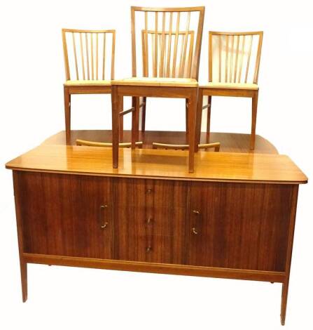 A 1950s/60s Vanson retro style mahogany dining room suite, comprising sideboard with brassed handles, extending dining table and six chairs, the sideboard 161cm W.