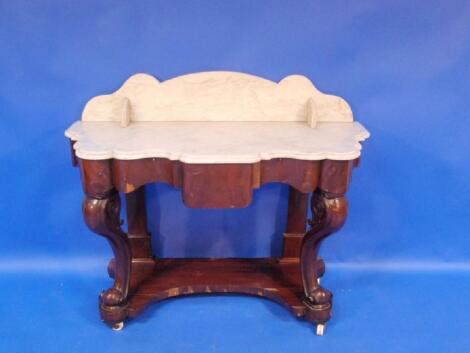 A Victorian flamed mahogany Duchess wash stand with shaped marble top