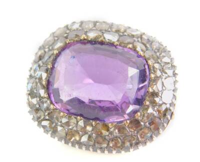 A Georgian amethyst and diamond brooch, the oval cut amethyst in a surround of old cut diamonds, in an open backed yellow and white metal setting, amethyst approx 8 1/2cts, 14.8g.