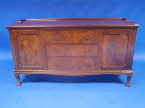 An Edwardian flamed mahogany sideboard with an arrangement of drawers and