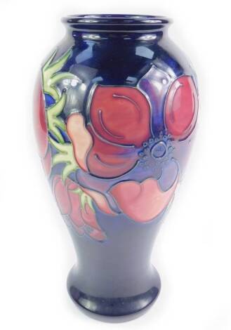 A Moorcroft pottery vase decorated in the Anemone pattern, of baluster form, against a cobalt blue ground, impressed and painted marks, 31.5cm H.