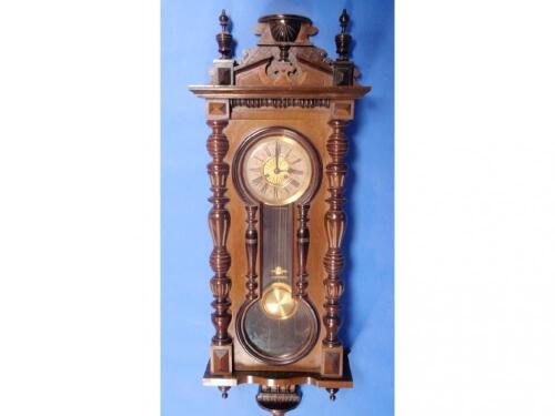 A late 19thC German walnut veneered wall clock with eight day movement