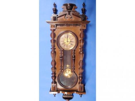 A late 19thC German walnut veneered wall clock with eight day movement