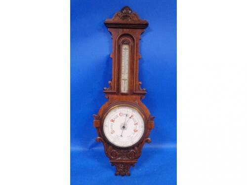 An Edwardian oak cased aneroid barometer