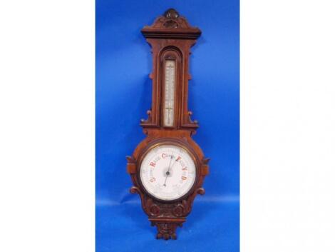 An Edwardian oak cased aneroid barometer