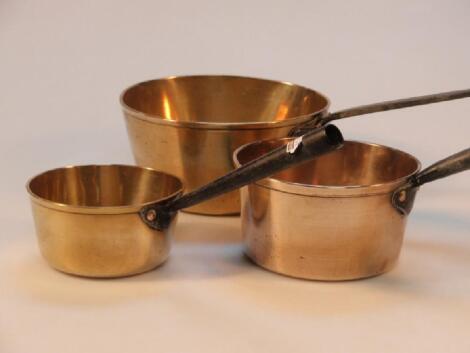 Two old brass saucepans and an old brass copper saucepan