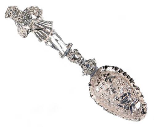 A late 19thC Dutch sifter spoon, with highly elaborate figure handle, repousée decorated bowl and part pierced stem, marked verso, import marks, white metal, 22cm W.