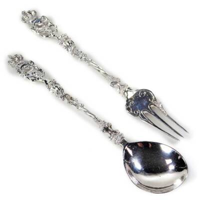 A late 19thC continental silver fork and spoon set, each piece with entwined pierced handles heavily repousée decorated with a coat of arms to the bowl of the spoon, London import marks for 1892, 15cm W, 1½oz. (2)