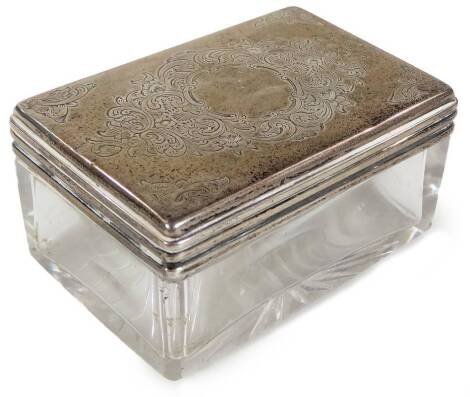 A Victorian silver topped glass box, of rectangular form with a removable lid, partially chased with scrolls and flowers, London probably 1874, 8cm W, 1oz. From the estate of R J ‘Bob’ Curry (Dec’d) of Grantham.