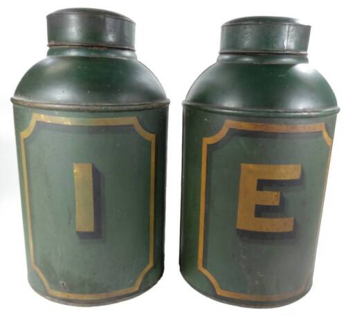 A pair of 19thC toleware tea tins, each in green tin, of shouldered circular form, one initialled E the other I, with gilt decoration and removable lids, 48cm H. (2)