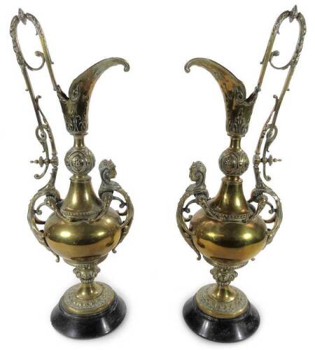 A pair of 19thC Empire design ewers, each with heavily chased scroll tops, acanthus handles and bulbous bodies, fronted by classical female figure heads on bead highlighted stems and ebonised bases, unmarked, 52cm H. (2)