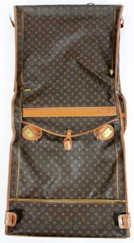 A Louis Vuitton luggage case, folding at the centre with zips and brown leather mounts, with LV flower head print decoration, 59cm W.