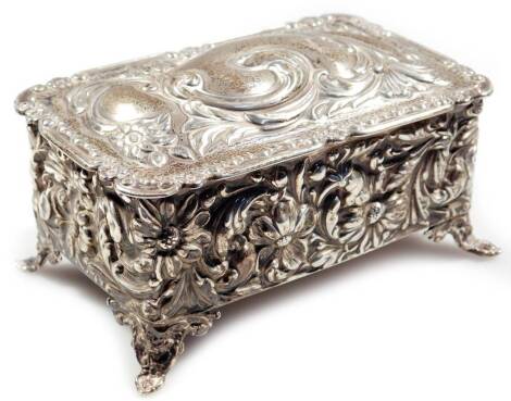 An Edwardian silver casket, of rectangular form, repousée decorated and heavily raised with scrolls and flowerheads, with a plain interior, on shaped feet, Birmingham 1905, 12cm W, 4oz.
