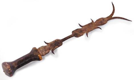 A 19thC ornamental metal headed tool, with shaped pierced and sharper edged blade and inverted wooden handle, 39cm W.