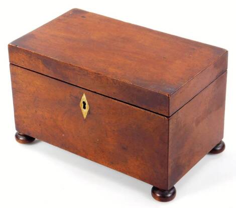 An early 19thC mahogany tea caddy, of rectangular form with lozenge escutcheon and a sectional interior, on compressed bun feet, 13cm H, 21cm W, 12cm D.