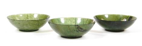 Three various green jade dishes, 8cm dia. (3)
