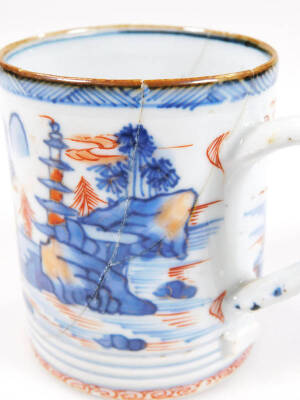 A Chinese Imari porcelain tankard, of cylindrical form, with ear shaped handle, heavily decorated with buildings, cliffs and a seascape, in orange and blue, on a circular foot, 7cm H. (AF) See Christies 22nd June 1989 Monaco lot 66 for a similar item. - 7