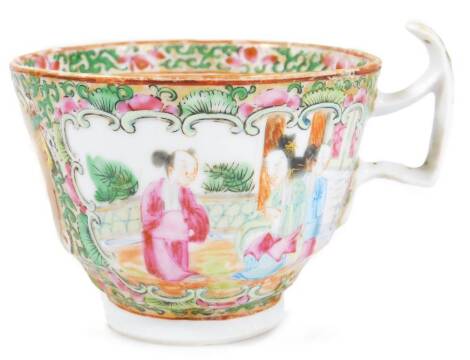 A 19thC Cantonese porcelain tea cup, with shaped handle, the circular bowl decorated with panels of figures in an interior setting, broken by further panels and flowerheads, in famille rose colours, predominately in pink, green, yellow and blue, on a circ
