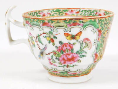 A 19thC Cantonese porcelain tea cup, with shaped handle, the circular bowl decorated with panels of figures in an interior setting, broken by further panels and flowerheads, in famille rose colours, predominately in pink, green, yellow and blue, on a circ - 3