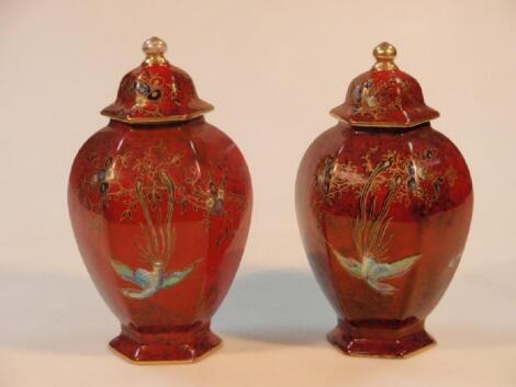 A pair of Wilton ware hexagonal ovoid vases and covers