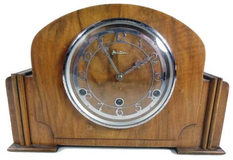 A 1950s Bentima walnut cased 8-day mantel clock, with chrome plated 13cm Dia. dial and three winding holes, with chiming movement in fitted shaped case, 22cm H.