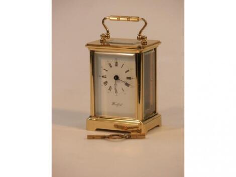 A gilt metal carriage clock