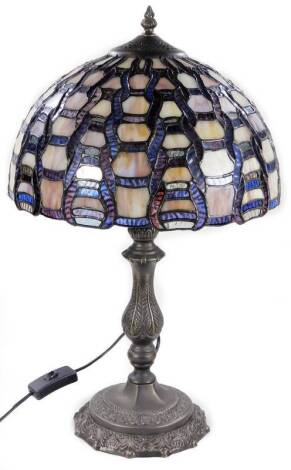A 20thC Tiffany style table lamp, with glass shade predominately in purple and lilac, on a metal stem and shaped base, 57cm H.