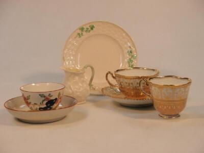 A second period Belleek cream jug with green handle