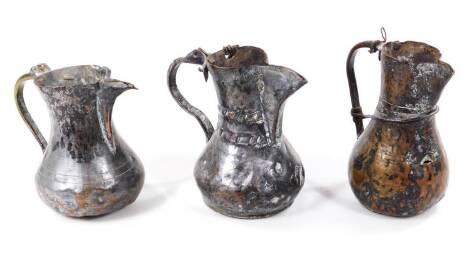 Three Palestinian open cast metal pots, each of bulbous form with beak spouts and shaped handles, 17cm H, etc. (3, AF)