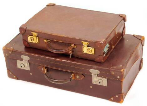 A mid 20thC brown leather travel case, with chrome plated mounts, 20cm H, 65cm W, 36cm D, and another smaller. (2)