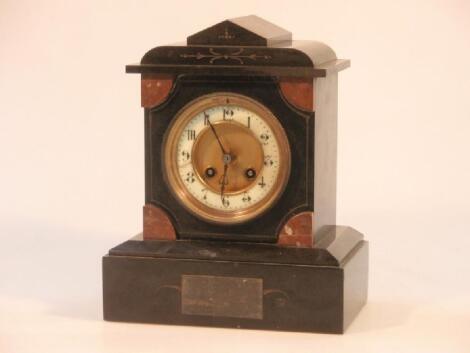A late Victorian slate mantel clock of eight-day movement striking on a gong