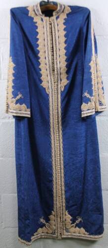 An early 20thC oriental dress, full length in blue with raised frills and elaborate front fastening, probably Indian.