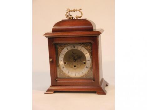 A reproduction George II style mahogany cased mantel clock