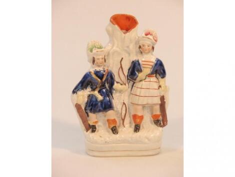 An 18thC Staffordshire figural spill vase of Hunters in underglaze blue