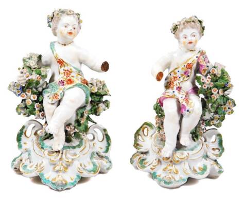 A pair of Derby porcelain cherubs, on rococo bases, patch mark, 18cm H. (2, AF)