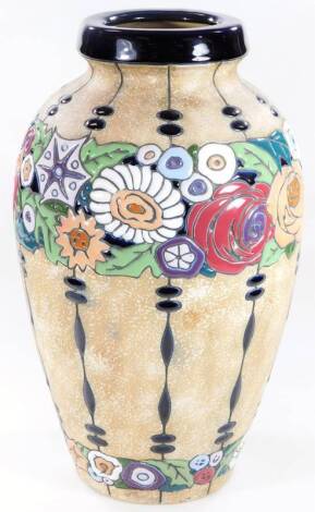 An early 20thC Amphora Austrian pottery vase, of shouldered form raised with an upper panel of flowers, polychrome decorated predominantly in green, white, and purple, with a blue rim, impressed marks beneath, 46cm H.