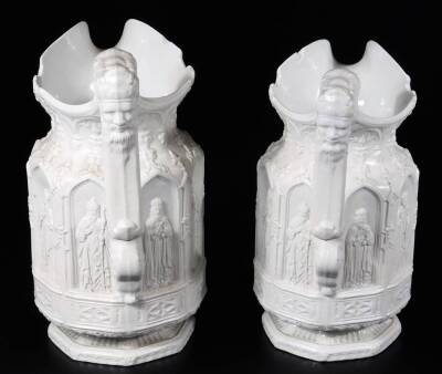 A pair of 19thC Charles Keige ecclesiastical jugs, each in cream with panels raised with figures and shaped thumb mould handles, on octagonal bases, raised purple marks beneath, 23cm H. (2) - 4