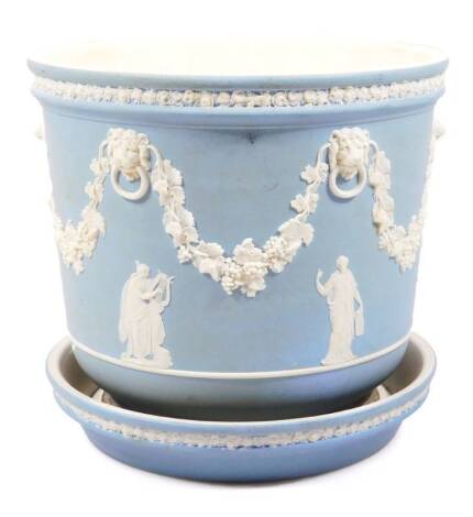 A late 19thC Wedgwood light blue Jasperware jardiniere, with an upper flowerhead border, the main body raised with garlands and acanthus leaves broken by lion’s mask ring mouldings, with further classical figures beneath, on a circular foot with separate 